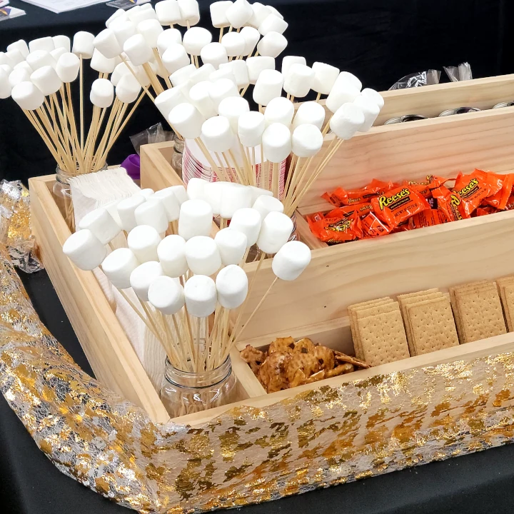 Delicious dessert catering near me: A s'mores station featuring marshmallows, chocolate, and graham crackers.